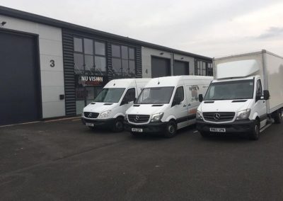 3 vans parked side by side from the Nu Vision Logistics fleet